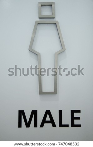 Sign of male toilet made from bending aluminum on white door background.