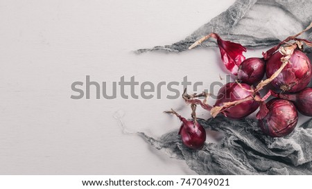 Ripe onion. On a wooden background. Top view. Free space for your text.