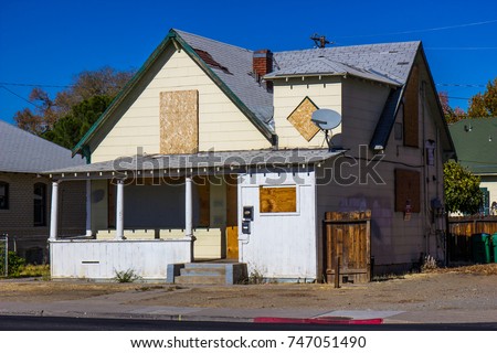 Old Boarded Up Home Lost To Foreclosure Royalty-Free Stock Photo #747051490