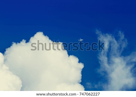 Blue sky and clouds with plane. Airplane flying in the blue sky among clouds and sunlight. picture background website or art work design. freedom with sky.