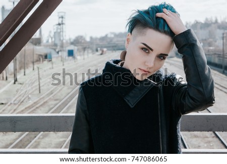 Lonely girl on a railway bridge.