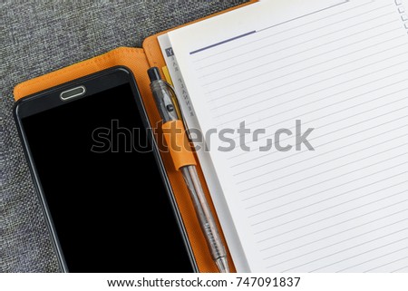 Office concept with note book and smartphone