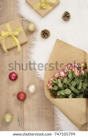Large luxury bouquet of roses, Christmas balls and gifts on a fur carpet