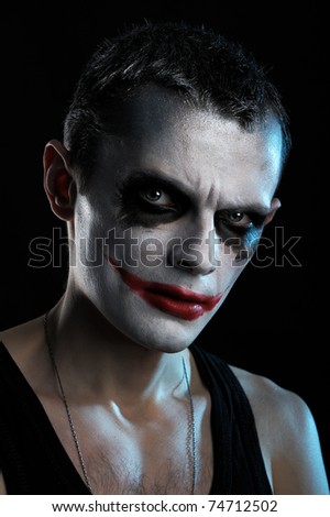 Spooky man joker on black background