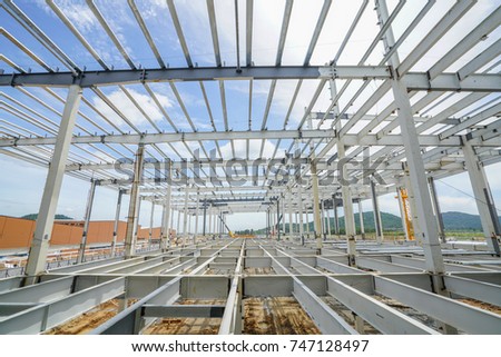Structure building of steel structure roof truss frame with steel structure mezzanine floor installation by mobile crane under the construction building in the factory with blue sky