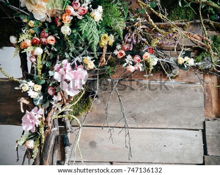 Wedding rustic wooden wall with flowers and branches