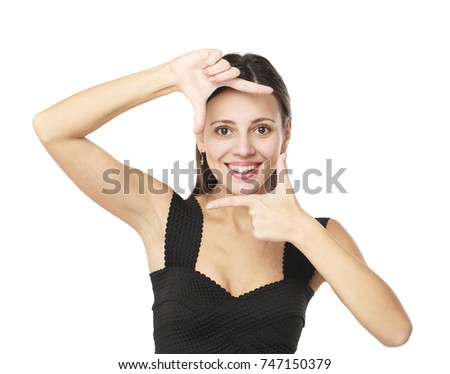 Portrait of young beautiful brunette woman making frame with her hands over white background