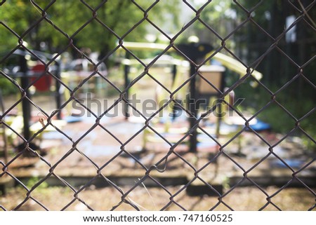 Rusty chain link fence with blur exercise machines,outdoor