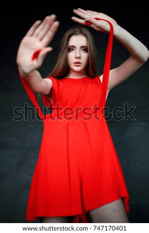 Girl in a red dress. Fashion photography