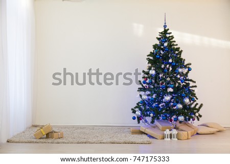 Christmas tree on Christmas day in a white room with gifts