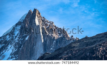 Helicopter flies over one of several peaks surround mont blanc