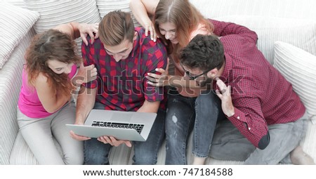 group of friends looking at the photo on the laptop.