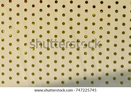 perforation abstract. Close up picture of Light Plastic Texture For Background. Background of brown modular plastic tiles. perforation. beige texture