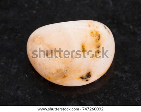 macro shooting of natural mineral rock specimen - polished Picture jasper gem stone on dark granite background from China