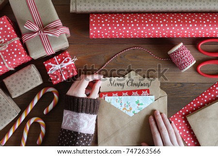 Female hands are packed by the Christmas letter