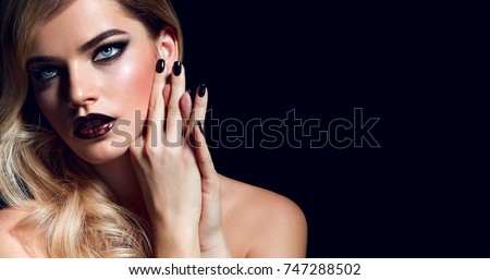 Blond girl in a rock style with makeup smoky ice in the studio on a black background.Makeup, cosmetics, make-up artist, beauty salon, hair, hairstyle, Hollywood chic, styling, stylist, hairdresser.