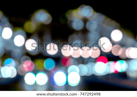 Blurred background of night city streets with bright car headlights