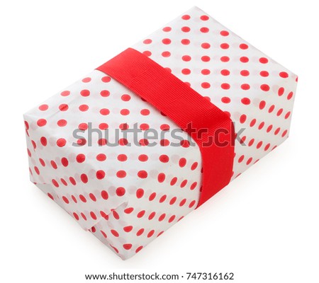 Gift box wrapped in white paper with red dots and bright red ribbon. Isolated on a white background, top view. 