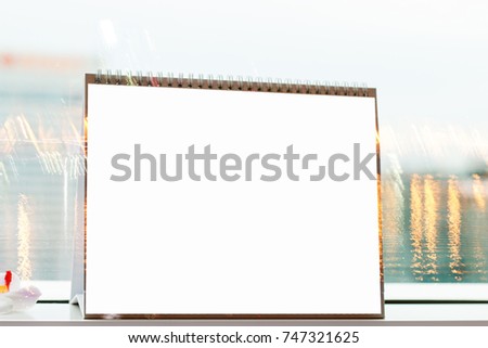 Mock up white Label for blank menu frame in Restaurant, Stand for booklets with white sheets paper tent card on table cafeteria, blurred light background can insert for text of customer.