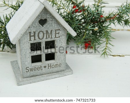 Decorative small house with sign Sweet home on white old vintage background.