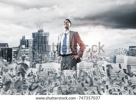 Young confident businessman in suit standing among flying letters with cityscape and sunlight on background. Mixed media.