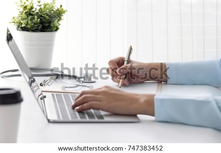 Medicine doctor technology or medical network. doctor using digital laptop with Write records
