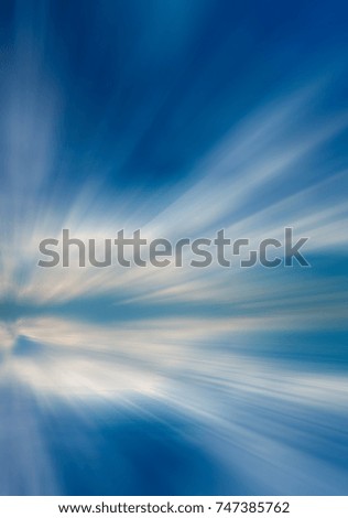 Different white clouds on a blue sky during the day over the sea. Abstract composition