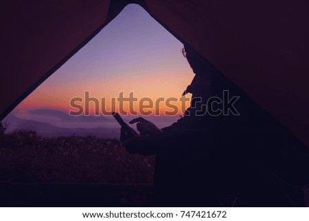 Messaging in camping tent on Mountains