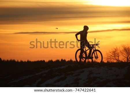 Estonia, Rakvere. Cyclist, sunset background. 