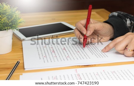 hand working on paper for proofreading Royalty-Free Stock Photo #747423190