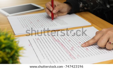 hand working on paper for proofreading Royalty-Free Stock Photo #747423196