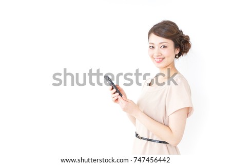 woman in dress using a smartphone