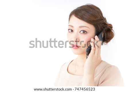 woman in dress using a smartphone