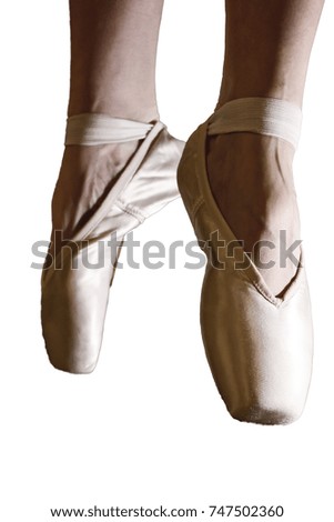 Feet of dancing ballerina on a white background in bright light