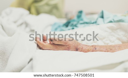 Patient in the hospital with incontinent pad and elderly patient hand
