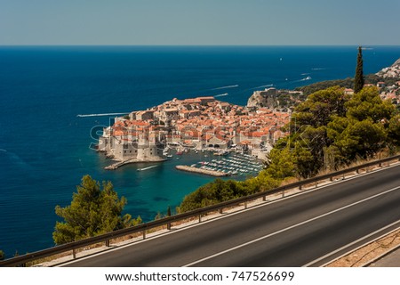 Panorama of Dubrovnik old town and Adriatic sea, Dalmatia Coast, Croatia, Europe and the road. Picture taken from the mountain trails above Dubrovnik citadel and the road in the summer seasson.