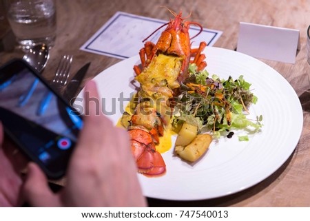 Mobile phone take a picture of lobster