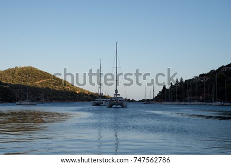 Anchored yachts on natural port in Mediterranean sea on sunset