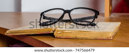 eyeglasses on the book
