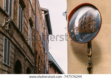 Reflector on empty rustic street corner in Siena, Tuscany, Italy
