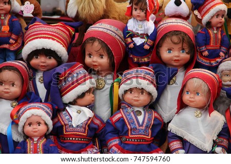 A collection of Saami dolls dressed in traditional Lapland clothing, sold as souvenirs in Finland. Royalty-Free Stock Photo #747594760