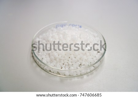 sodium hydroxide pallet on glass plate Royalty-Free Stock Photo #747606685