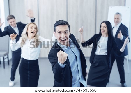 Successful male person making strong fist