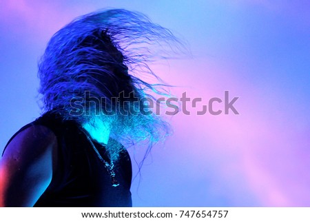 Rock singer with long hairs Royalty-Free Stock Photo #747654757