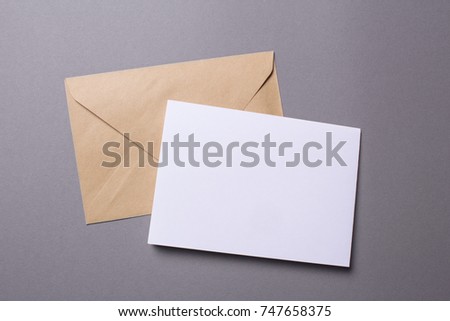 Mock-up letter or postcard with envelope on a gray background