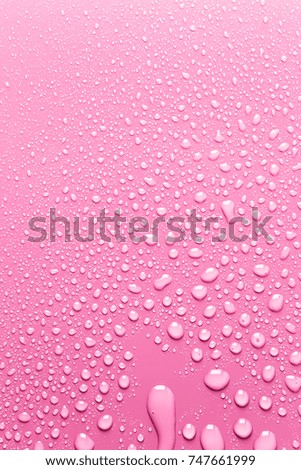 Smooth and clean pink surface with drops of water
