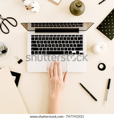 Flat lay home office desk on beige background. Woman working on laptop. Top view female background. Lifestyle blog hero.