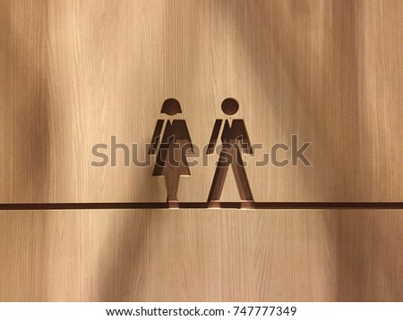 Men And Lady Sign Toilet On Wood Background. Wood Brown Grain Texture. Selective Focus. Image For Templates, Placards, Banners, Presentations, Reports, Card. etc