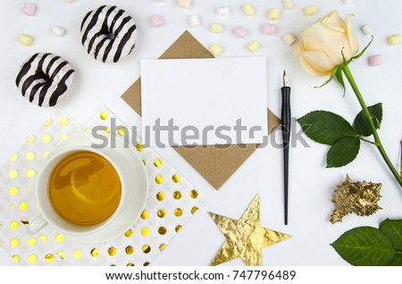 Romantic letter with copy space for your text.Top view, flatlay. Mockup template. Romantic morning motive, tea, rose and sweet donuts.