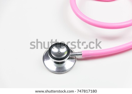 image of pink stethoscope over a white background / With Copy Space